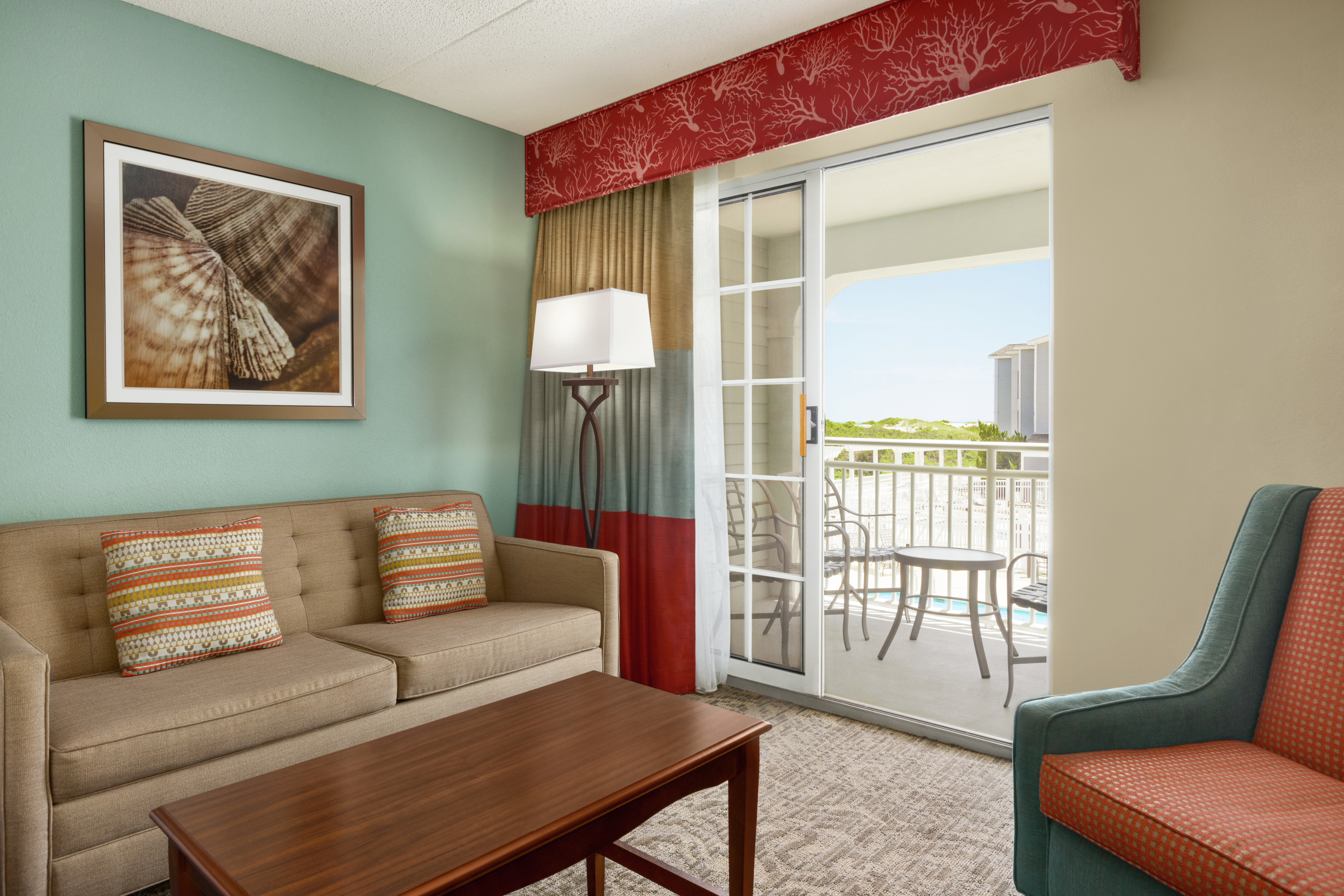 Spacious lounge area in guestroom with walkout to private balcony.