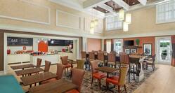 Spacious breakfast seating area featuring ample natural light and complimentary buffet.