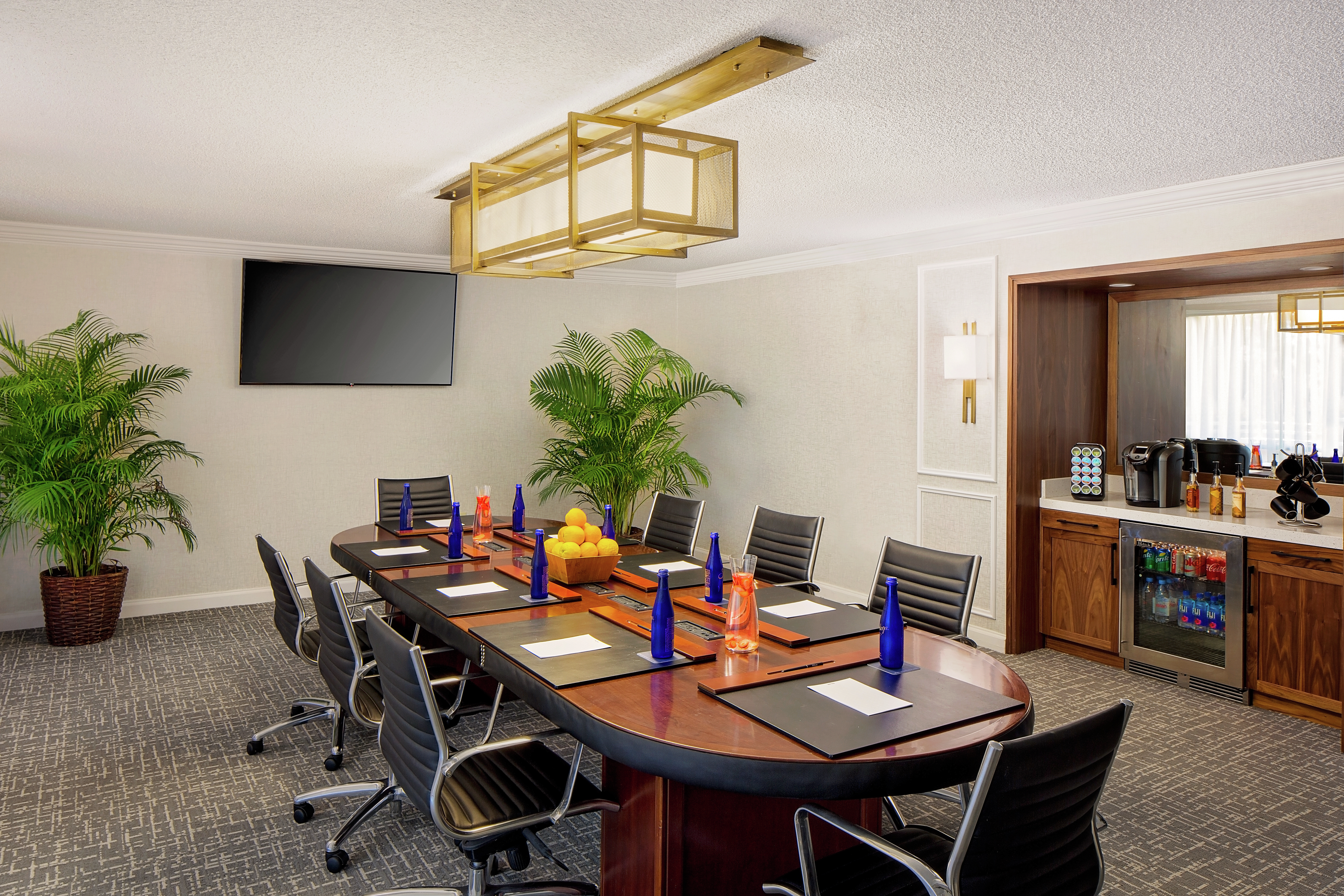 Meeting Room with Table, Office Chairs, Wall Mounted HDTV and Beverage Station