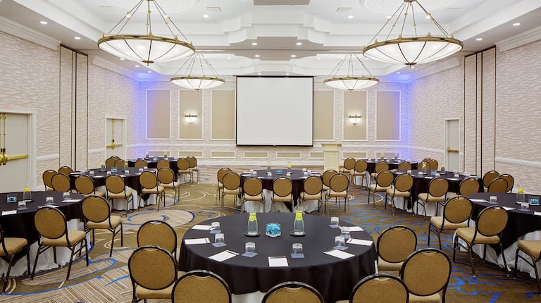 Ballroom Area with Round Tables, Chairs and Projector Screens