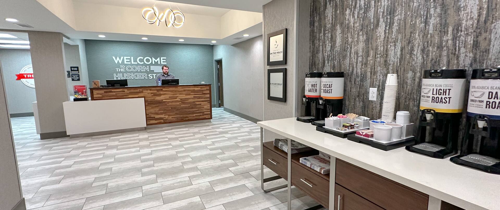 Reception Desk Area with Team Member and Close Up View of Coffee Service Area