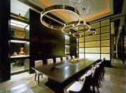 View of Meeting Room Interior With Mirrored Cabinet, Decorative Lighting, and Seating for 12 at Boardroom Table