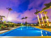 Outdoor Pool Area at Night with Palm Trees