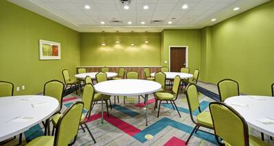 Meeting room with round tables and chairs.