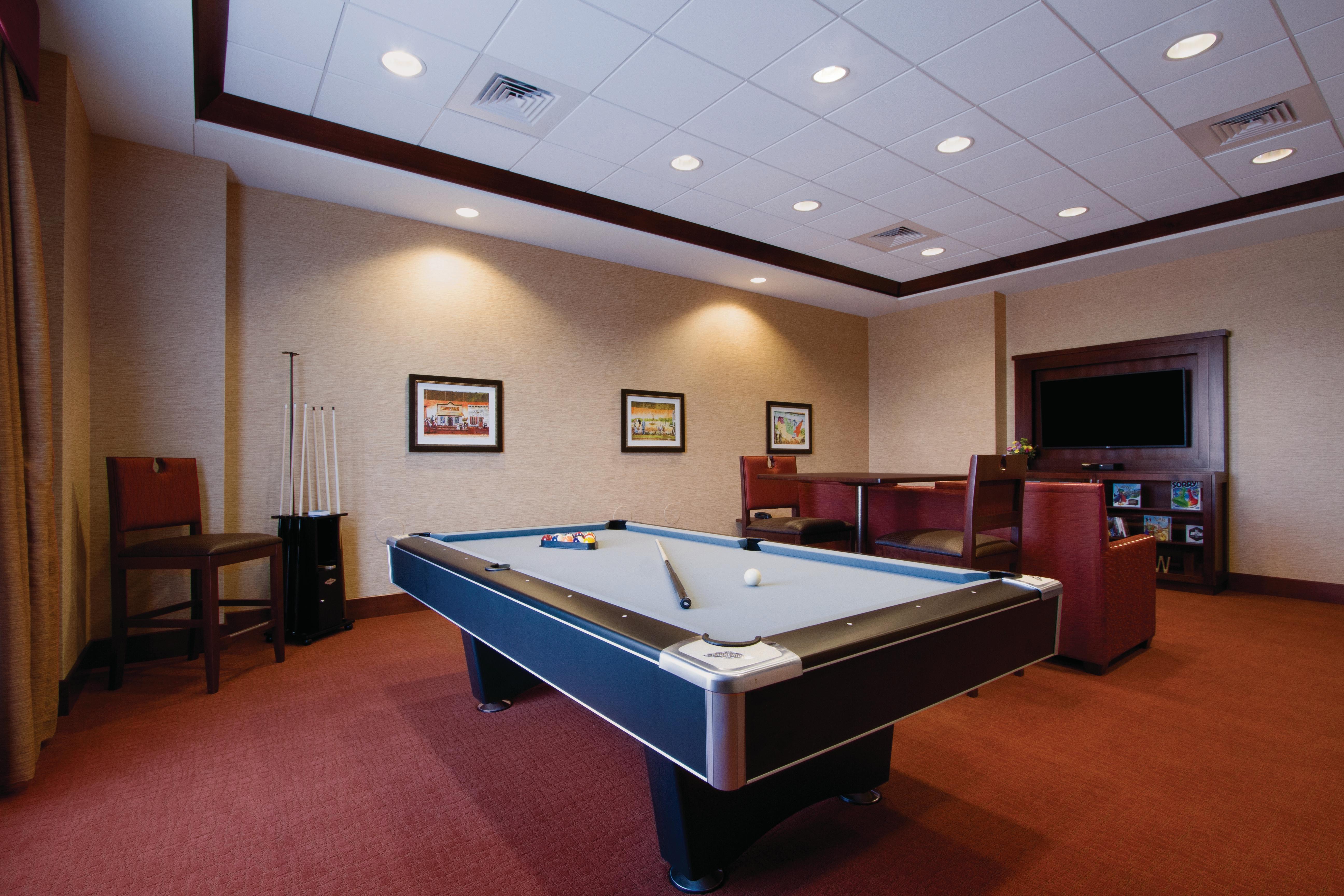 Game Room With Pool Table, Bar Style Seating, Sofa, TV and Wall Art