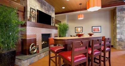 Community Table With Seating For Six By Fireplace and TV