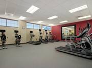 Fitness Center With Cardio Equipment and Large Mirror