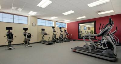 Fitness Center With Cardio Equipment and Large Mirror