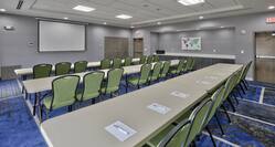 Meeting Room in Classroom Setup with Projector Screen and Seats for 27 People
