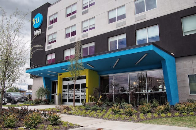 Hotel Exterior with Signage, Sidewalk, and Landscaping
