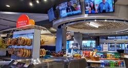 Breakfast Area with TVs and Market with Bagels, Donuts, and Assorted Beverages
