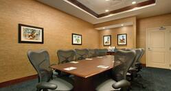 Ergonomic Seating for 10 at Table in Boardroom With Wall Art and View of Entry