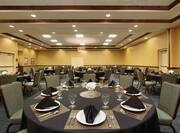 Place Settings Flowers, and Chairs at Banquet Tables With Black Linens in Washita Meeting Room