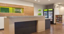  Green Sign Behind Front Desk With Apples on the Counter and View of the Snack Shop