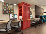 Business Center with Colorful Wall Art, Two Computers on Work Desk, Four Ergonomic Chairs, Red Storage Cabinet With Printer and Two Blue Armchairs by Illuminated Floor Lamp
