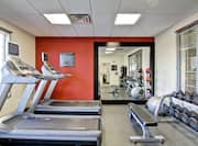 Fitness Center with Cardio Equipment Facing Window, Large Mirror,Weight Bench, Weight Balls, Exercise Ball, and Free Weights