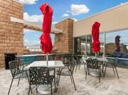 Tables With Chairs and Red Umbrellas on Patio