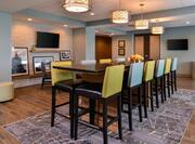 Breakfast Seating Area with Tall Dining Table, Tall Chairs and Two Wall Mounted HDTVs
