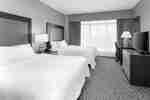 two double beds with desk and tv