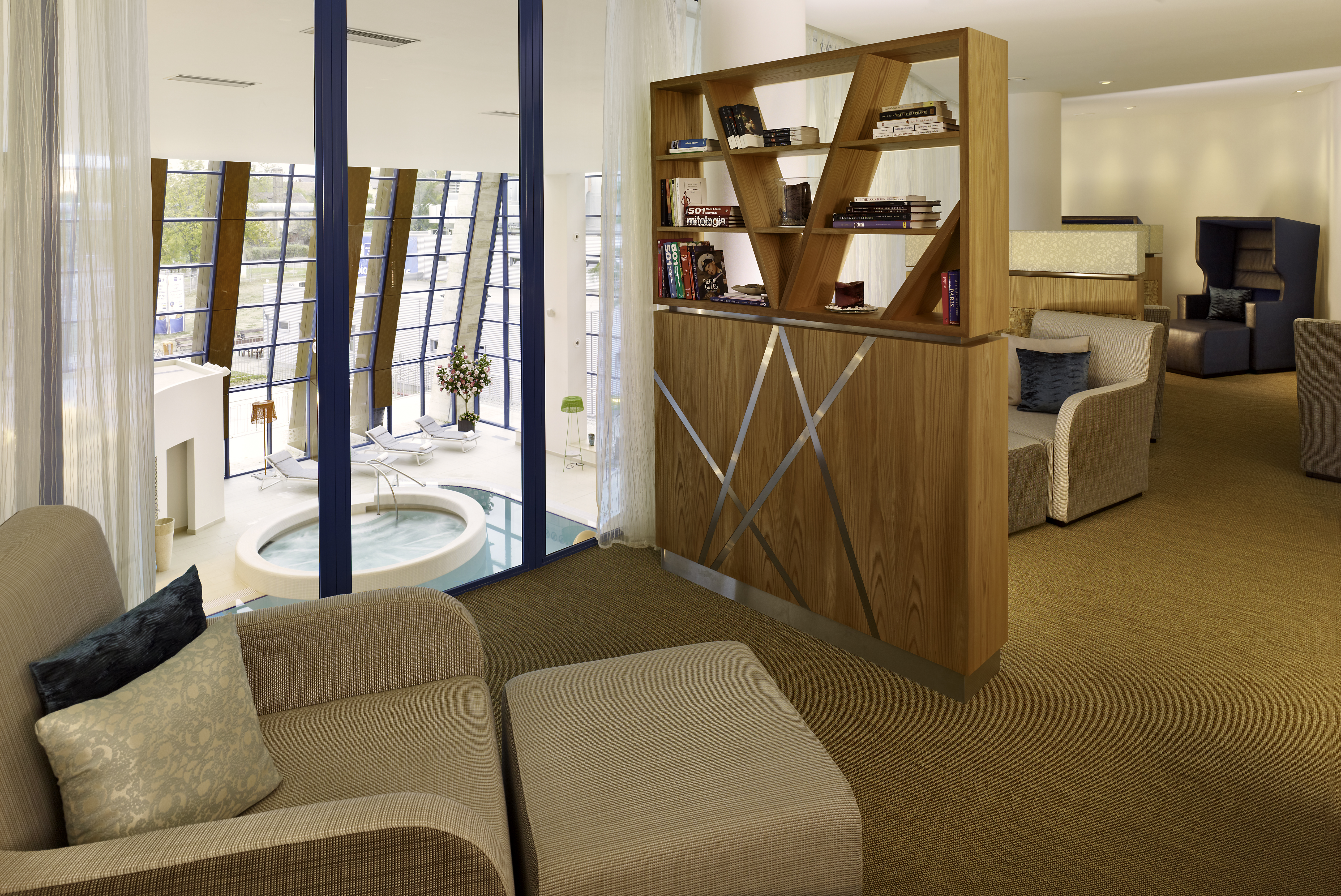 Soft Seating, Wood Shelves, and Large Window With Jot Tub View in Transition Lounge at Eforea Spa