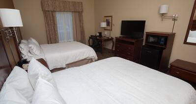 Two Beds HDTV Desk and Microwave in a Hotel Guest Room