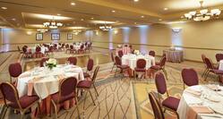 a ballroom room with banquet tables and a dance floor