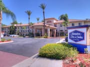 Exterior shot of  hotel with Hampton Inn & Suites sign