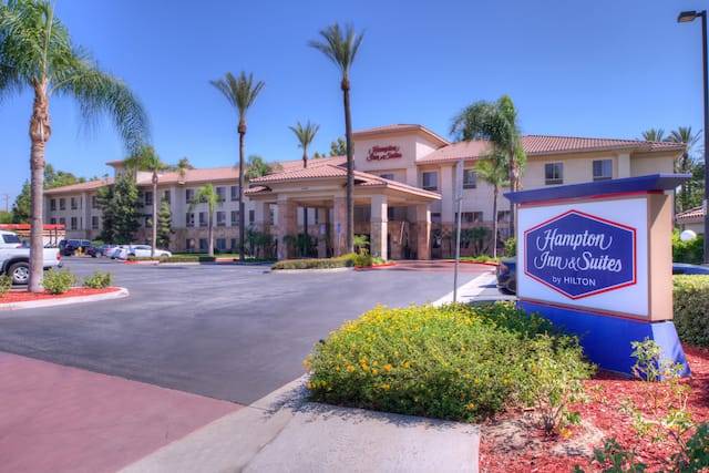 Exterior shot of hotel with Hampton Inn & Suites sign