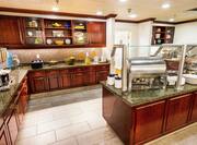 Kitchen with Cabinets and Granite Tables