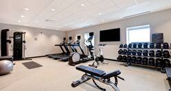 fitness center with exercise machines and weights