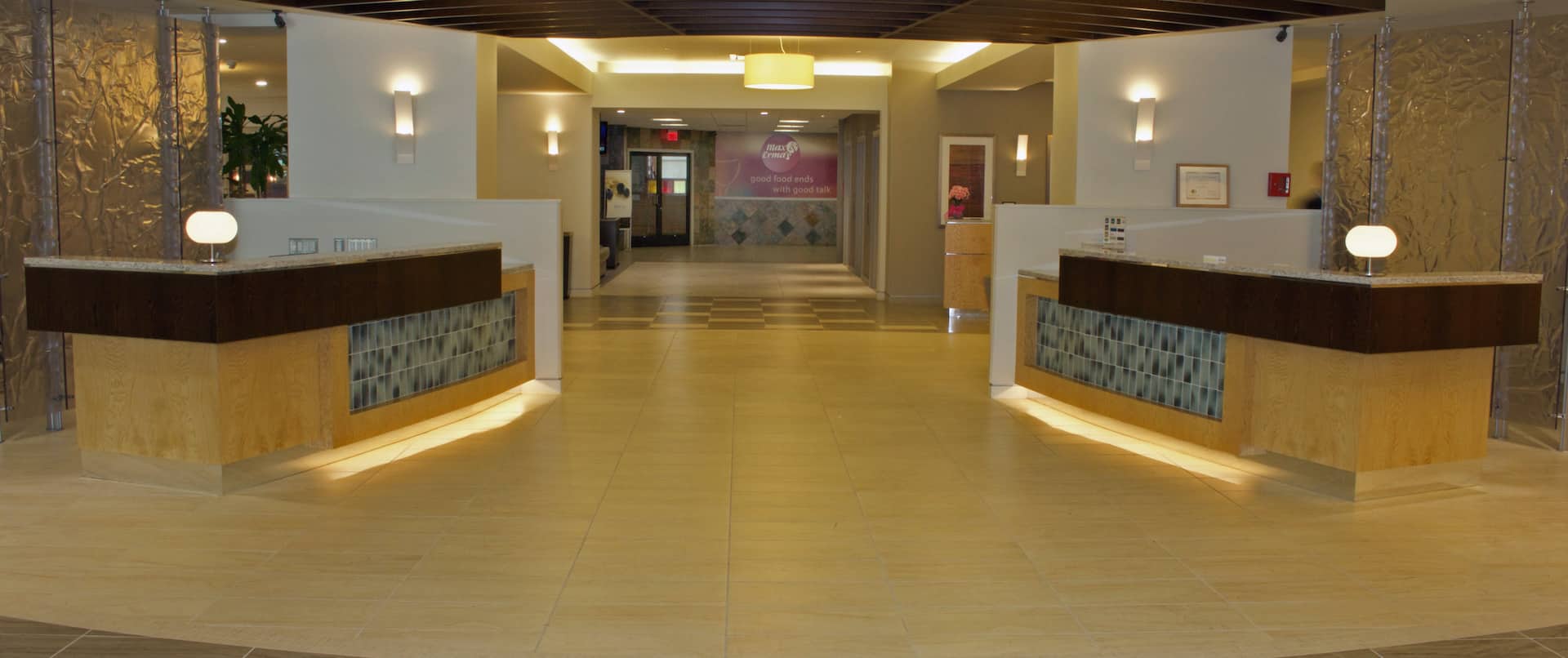 Reception Desks With Illuminated Lamps and View Down Lobby Corridor
