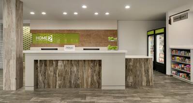 Welcoming front desk in lobby with convenient snack market.