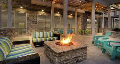 Beautiful outdoor patio area featuring comfortable seating, firepit, and gazebo.