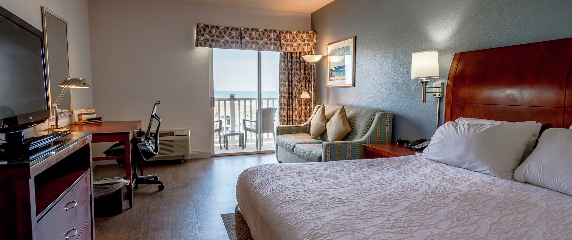 King Guestroom with Bed, Room Technology, Work Desk, Lounge Area, and Patio with Oceanview