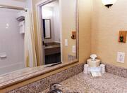 Guestroom Bathroom with Mirror, Vanity, and Amenities