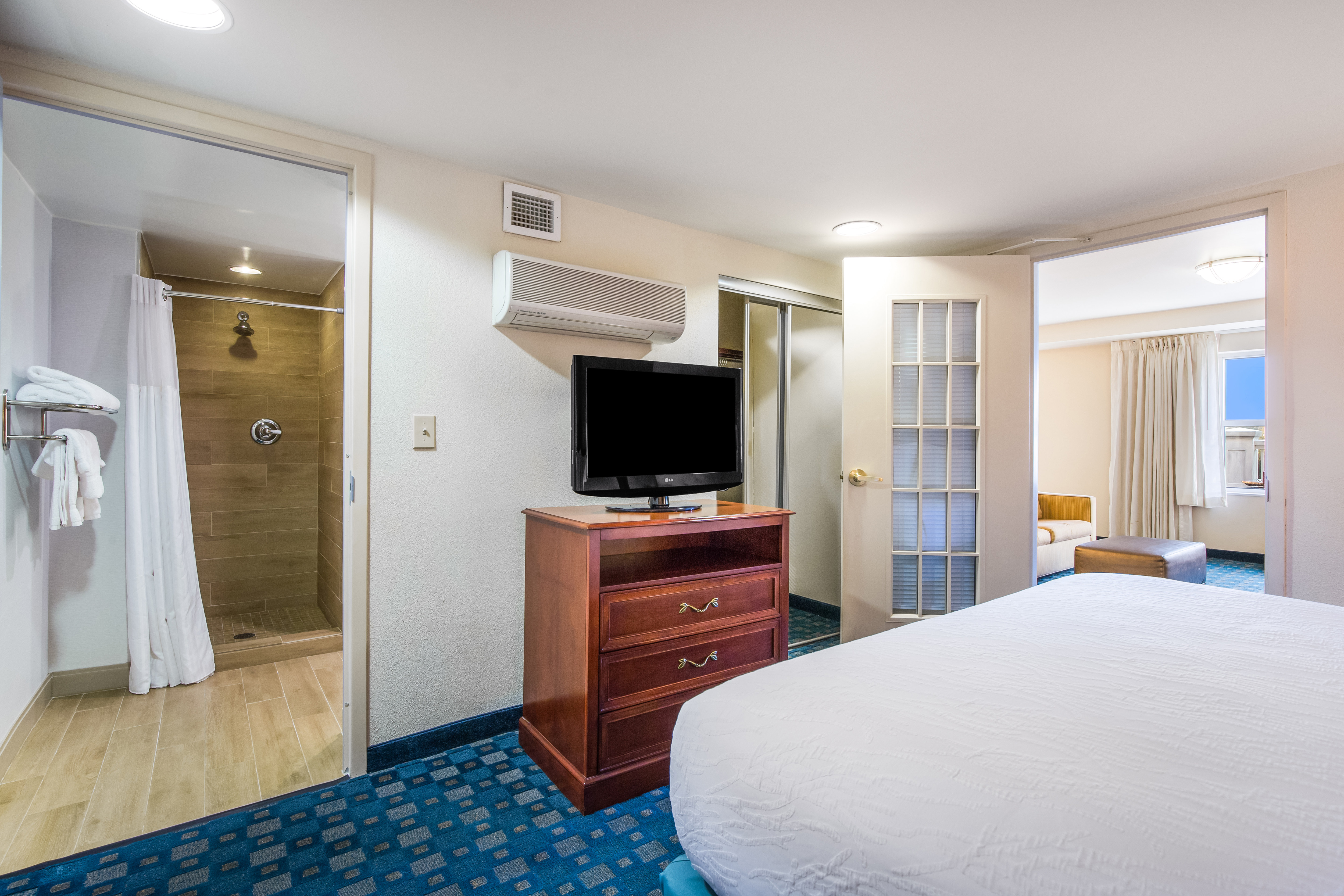 Guest Suite, King Bed, TV, Partial View of Bathroom and Living Area
