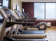 Fitness Center With Cardio Equipment and Frosted Windows