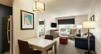 King Suite Living Area with Dining Table for Two, Sofa, Outside View, HDTV and Kitchen