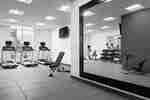 Fitness Center with Mirrored Wall, Treadmills and TV