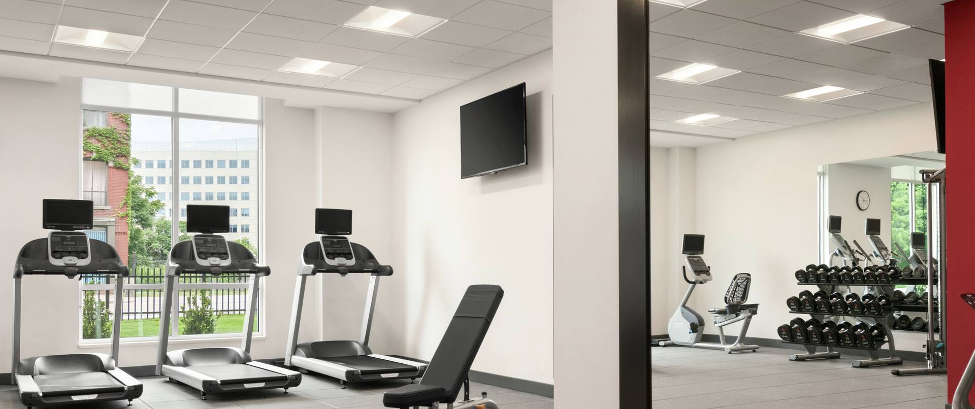 Fitness Center with Mirrored Wall, Treadmills and TV