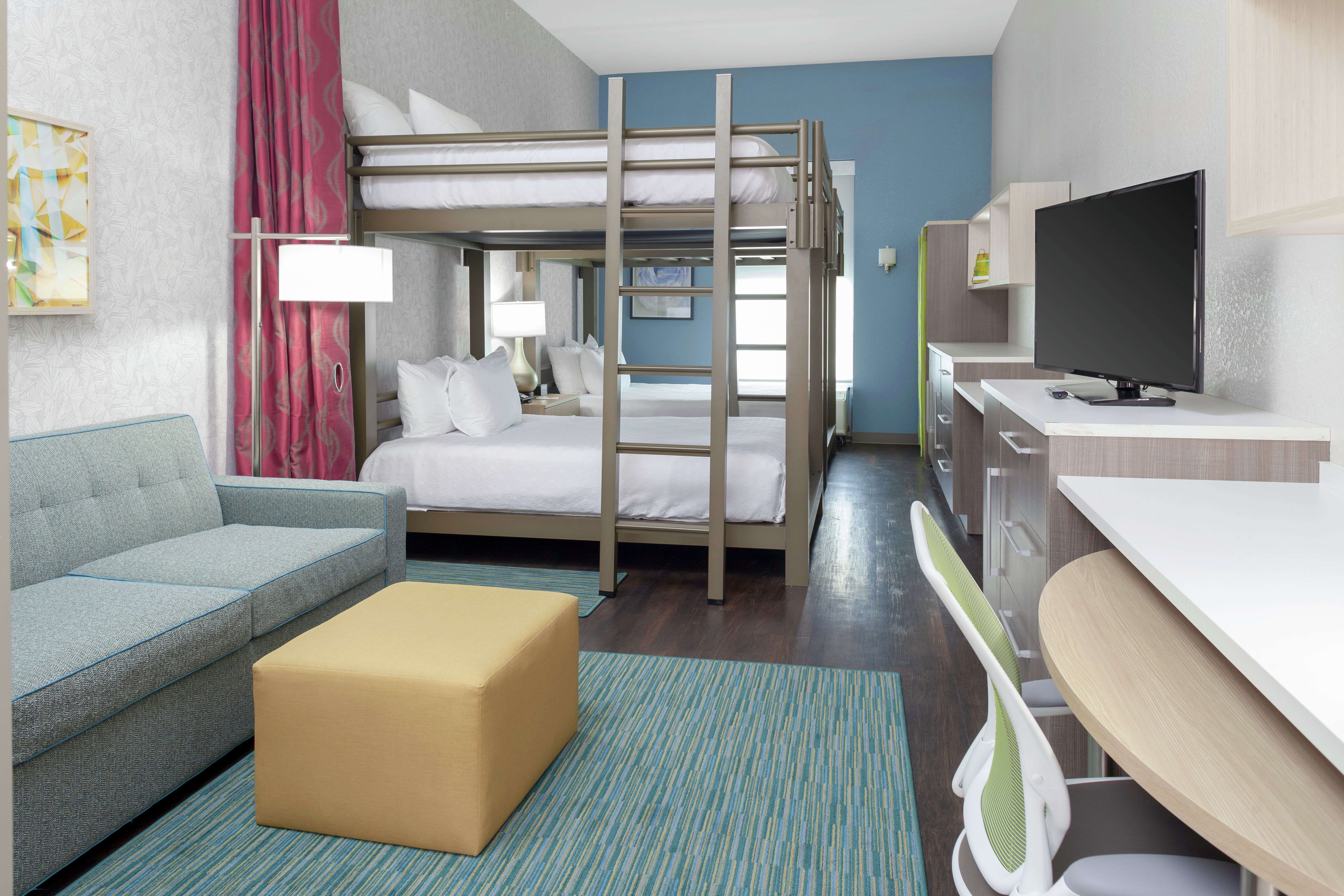 Guest Suite with Bunk and Queen Beds, Lounge Area, TV, and Work Desk