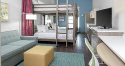 Guest Suite with Bunk and Queen Beds, Lounge Area, TV, and Work Desk