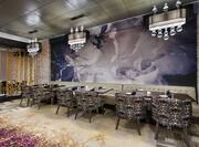 Black Napkins and Drinking Glasses on Dining Tables, Booth and Chair Seating, and Large Art Feature in Mingos Dining