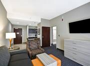 Homewood Suites by Hilton Orlando Theme Parks - Living Room with Sofa, Dresser, TV, Chair and Tables