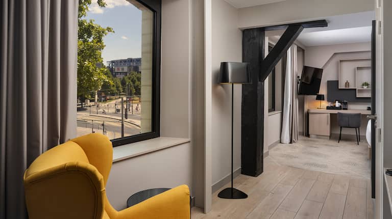 Guest Room with a Lounge Area, Coffee Station, and Flatscreen TV