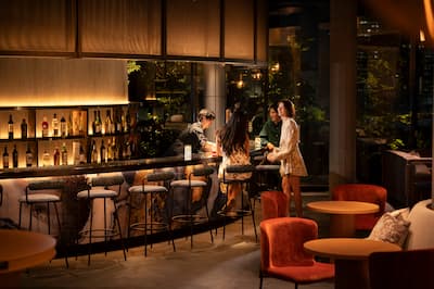 People Enjoying Drinks and Talking at JaJa Bar