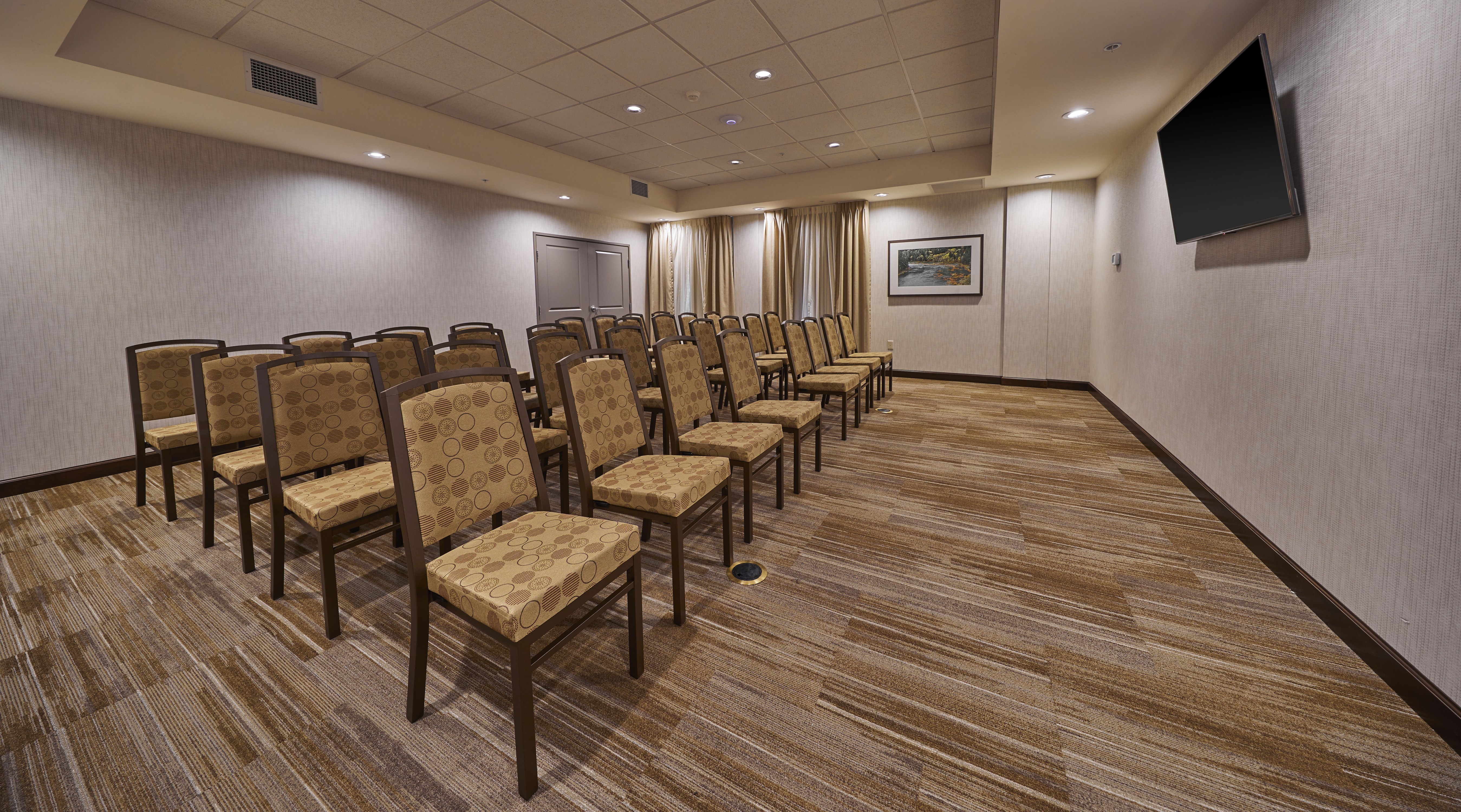 Meeting Room with Chairs and Wall-Mounted TV Screen