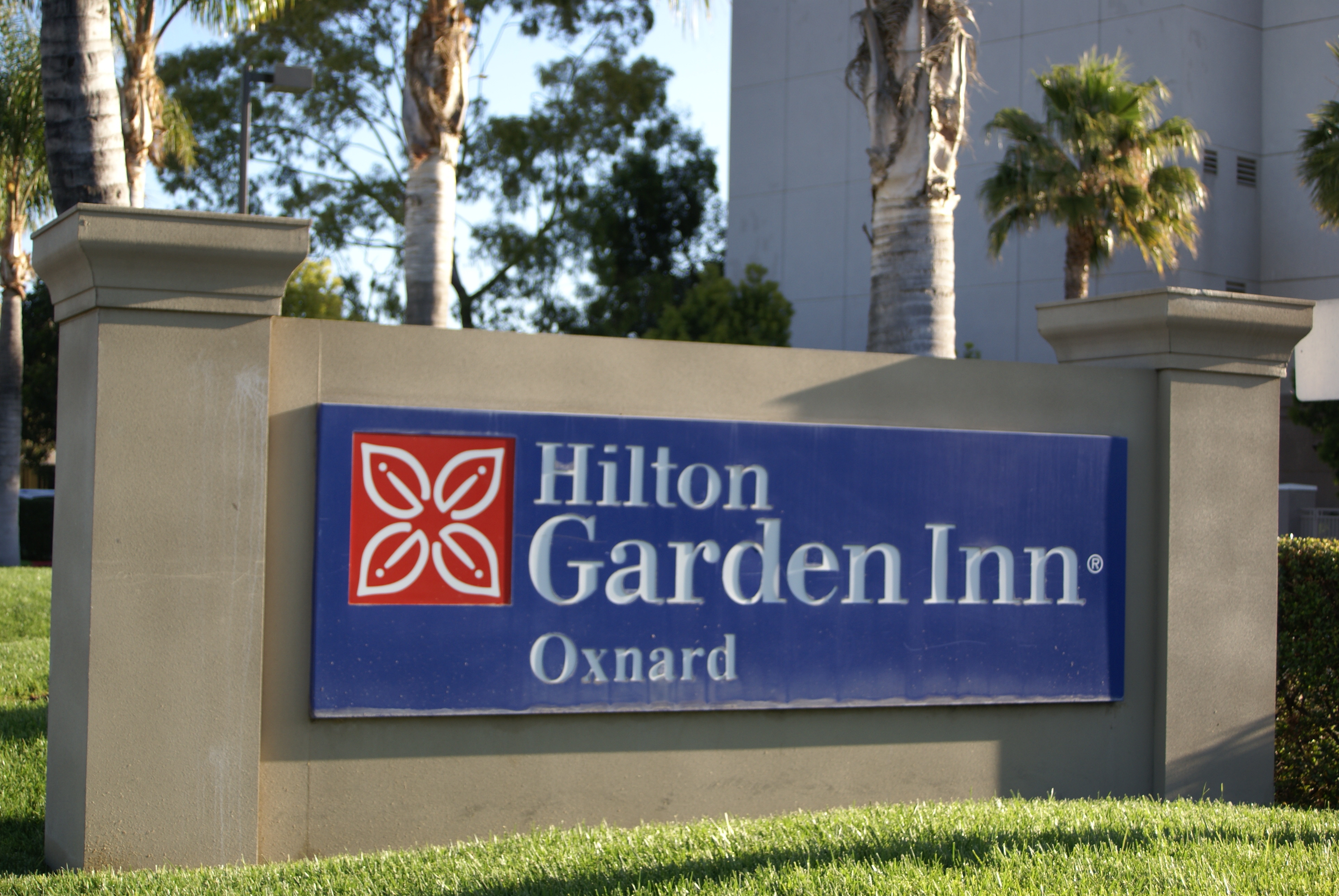 Daytime View of Hotel Signage and Landscaping
