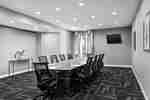 Spacious on-site meeting room featuring large boardroom table and TV.