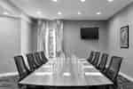 Spacious on-site meeting room featuring large boardroom table and TV.
